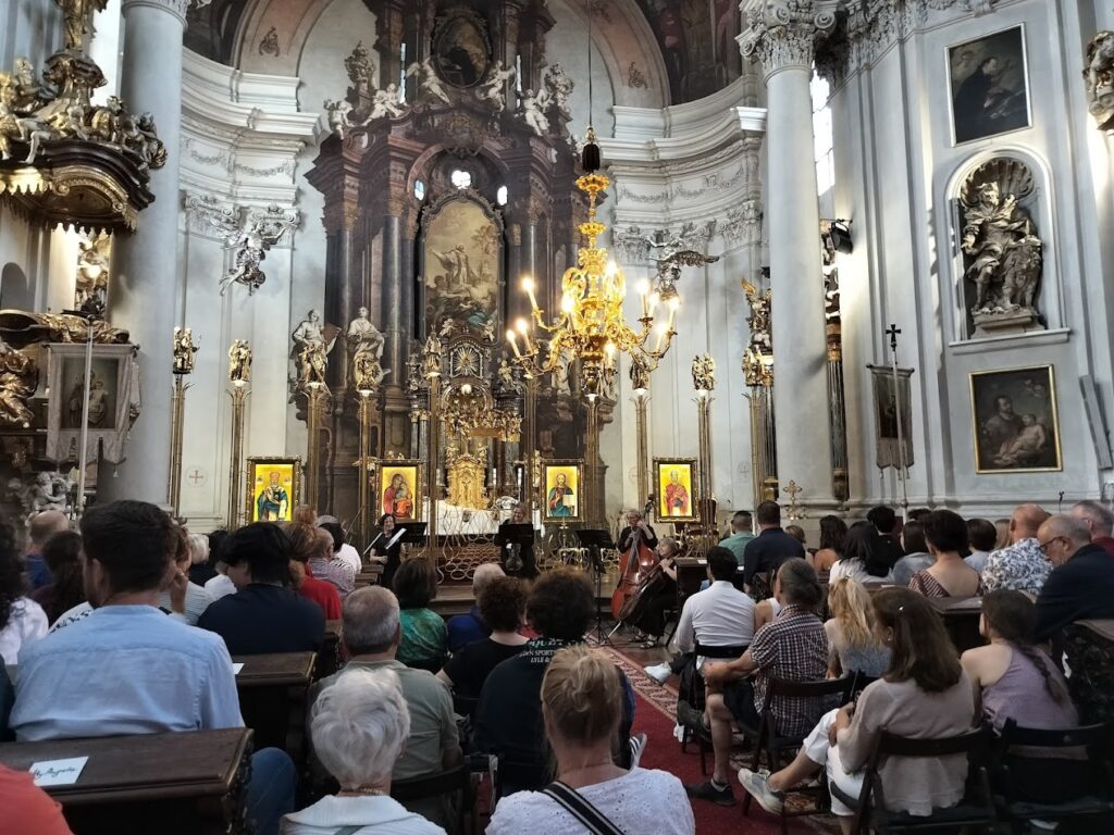 The gold and ornate interior of St. Clement Cathedral Prague